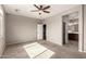 Large bedroom featuring neutral carpet, ceiling fan, access to bath at 23195 S 226Th Way, Queen Creek, AZ 85142