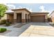 Charming single-story home with a two-car garage, covered porch, and landscaped front yard at 23195 S 226Th Way, Queen Creek, AZ 85142