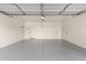 The garage has a light grey epoxy floor, white walls, and two doors at the back of the space at 23195 S 226Th Way, Queen Creek, AZ 85142