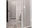This hallway has grey-tone tile floors with white trim and doors leading to other rooms at 23195 S 226Th Way, Queen Creek, AZ 85142