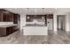Modern kitchen with dark cabinets, stainless steel appliances, granite countertops, and a spacious island at 23195 S 226Th Way, Queen Creek, AZ 85142