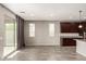 Open living space with dark cabinetry, wood-look tile flooring, and sliding glass doors to the backyard at 23195 S 226Th Way, Queen Creek, AZ 85142