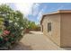 View of a landscaped backyard with gravel, a small patio, and a tan stucco exterior at 2327 E Meadow Land Dr, San Tan Valley, AZ 85140