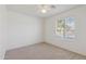 This bedroom is bright, featuring neutral carpet, a ceiling fan, and natural light at 2327 E Meadow Land Dr, San Tan Valley, AZ 85140