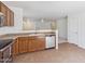 View of the kitchen with stainless steel appliances, tile flooring, and wooden cabinets at 2327 E Meadow Land Dr, San Tan Valley, AZ 85140