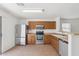 Bright kitchen boasts stainless steel appliances, tile floors, and wood cabinets at 2327 E Meadow Land Dr, San Tan Valley, AZ 85140