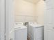 This laundry room features a full-sized washer and dryer, and storage shelving at 2327 E Meadow Land Dr, San Tan Valley, AZ 85140