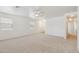 Bright living room features neutral carpet, white walls, and window views of the landscaped outdoors at 2327 E Meadow Land Dr, San Tan Valley, AZ 85140