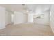Spacious open-plan living room features neutral carpet, ceiling fan, and bright, neutral paint at 2327 E Meadow Land Dr, San Tan Valley, AZ 85140