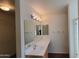 A bathroom with a large mirror, vanity with drawers, and bright lighting creates a welcoming space at 23424 W Pima St, Buckeye, AZ 85326