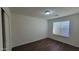 Empty bedroom with closet, window, and hard surface flooring at 23424 W Pima St, Buckeye, AZ 85326
