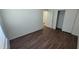 Comfortable bedroom with wood-look floors and a double door closet provides ample storage at 23424 W Pima St, Buckeye, AZ 85326
