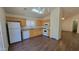 Bright kitchen with wood cabinets, white appliances, and hard surface floors at 23424 W Pima St, Buckeye, AZ 85326