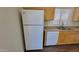 Kitchen with wood cabinets, laminate countertops, and white appliances at 23424 W Pima St, Buckeye, AZ 85326