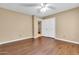 Bedroom with wood flooring, ceiling fan and double door closet at 2346 E Jasmine St, Mesa, AZ 85213