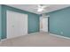 Bedroom featuring carpet, a ceiling fan and double door closet at 2346 E Jasmine St, Mesa, AZ 85213