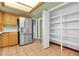Kitchen featuring a stainless steel refrigerator, tile flooring, and a walk in pantry with shelving at 2346 E Jasmine St, Mesa, AZ 85213