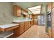 An open concept kitchen featuring stainless steel appliances, tile floors and wooden cabinets at 2346 E Jasmine St, Mesa, AZ 85213