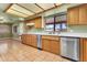 Bright kitchen with modern stainless steel appliances, wooden cabinets, and tile floors, well lit at 2346 E Jasmine St, Mesa, AZ 85213