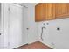 Laundry area with wood cabinets and tiled floors, ready for your appliances at 2346 E Jasmine St, Mesa, AZ 85213