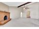 Large living room featuring a brick fireplace, decorative arches and neutral colored carpet at 2346 E Jasmine St, Mesa, AZ 85213