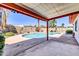 Covered patio overlooking a refreshing private pool and landscaped yard, perfect for entertaining at 2346 E Jasmine St, Mesa, AZ 85213