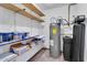 Utility area with shelves, hot water tank, and water filtration system at 2346 E Jasmine St, Mesa, AZ 85213