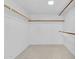 Walk-in closet with multiple wood rods for storage at 2346 E Jasmine St, Mesa, AZ 85213