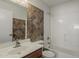 Bathroom featuring brown patterned tile accent wall, toilet, bathtub, shower and sink at 2408 W Saint Kateri Dr, Phoenix, AZ 85041