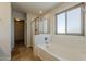 Bright bathroom with white bathtub and glass enclosed shower at 2408 W Saint Kateri Dr, Phoenix, AZ 85041