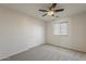 This bedroom features neutral carpet, a ceiling fan, and a closet for storage at 2408 W Saint Kateri Dr, Phoenix, AZ 85041
