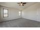 This bedroom features neutral carpet and two windows that let in ample light at 2408 W Saint Kateri Dr, Phoenix, AZ 85041