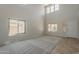 Bright living room featuring high ceilings, neutral carpet, and lots of natural light with many windows at 2408 W Saint Kateri Dr, Phoenix, AZ 85041