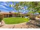 Expansive backyard featuring a well-manicured lawn, vibrant landscaping, a pool, and mature trees at 2920 W Michigan Ave, Phoenix, AZ 85053