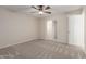 Neutral bedroom with carpet, ceiling fan, and an open doorway to another room at 2920 W Michigan Ave, Phoenix, AZ 85053