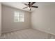 Neutral bedroom with ceiling fan, carpet, window with shutters, and light walls at 2920 W Michigan Ave, Phoenix, AZ 85053