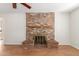 Living room showcasing a brick fireplace, wooden mantle and hearth seating at 2920 W Michigan Ave, Phoenix, AZ 85053