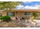 Inviting front entrance with a well-maintained walkway, colorful potted plants, and decorative stones at 2920 W Michigan Ave, Phoenix, AZ 85053