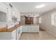 Bright kitchen with white cabinets, tile floors and wood countertops at 2920 W Michigan Ave, Phoenix, AZ 85053