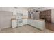 Bright kitchen featuring white appliances, wood countertops, tile floor and brick fireplace at 2920 W Michigan Ave, Phoenix, AZ 85053