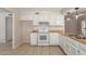 Bright kitchen featuring white appliances, tile floors and wood countertops at 2920 W Michigan Ave, Phoenix, AZ 85053