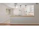 Kitchen featuring breakfast bar, wood countertops and modern pendant lighting at 2920 W Michigan Ave, Phoenix, AZ 85053