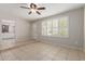 Open-concept living room with tile flooring, natural light, and access to kitchen at 2920 W Michigan Ave, Phoenix, AZ 85053