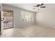Bright living room with tile flooring, large windows, and a ceiling fan at 2920 W Michigan Ave, Phoenix, AZ 85053