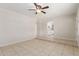 Spacious living room featuring neutral walls, tile flooring, and an open layout with kitchen view at 2920 W Michigan Ave, Phoenix, AZ 85053