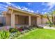 Covered patio area featuring a tiled floor, pillars, and a colorful flowerbed, ideal for outdoor relaxation at 2920 W Michigan Ave, Phoenix, AZ 85053