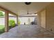 Covered patio area with tile floor, featuring landscaped yard with mature plants and trees at 2920 W Michigan Ave, Phoenix, AZ 85053