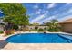 Sparkling pool with desert landscaping and rock accents, providing a cool and inviting outdoor retreat at 2920 W Michigan Ave, Phoenix, AZ 85053