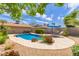 Sparkling pool with a stone surround and desert landscaping, perfect for relaxation and outdoor enjoyment at 2920 W Michigan Ave, Phoenix, AZ 85053