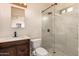 Modern bathroom featuring a walk-in shower, dark wood vanity, and updated fixtures at 2936 E Willetta St, Phoenix, AZ 85008
